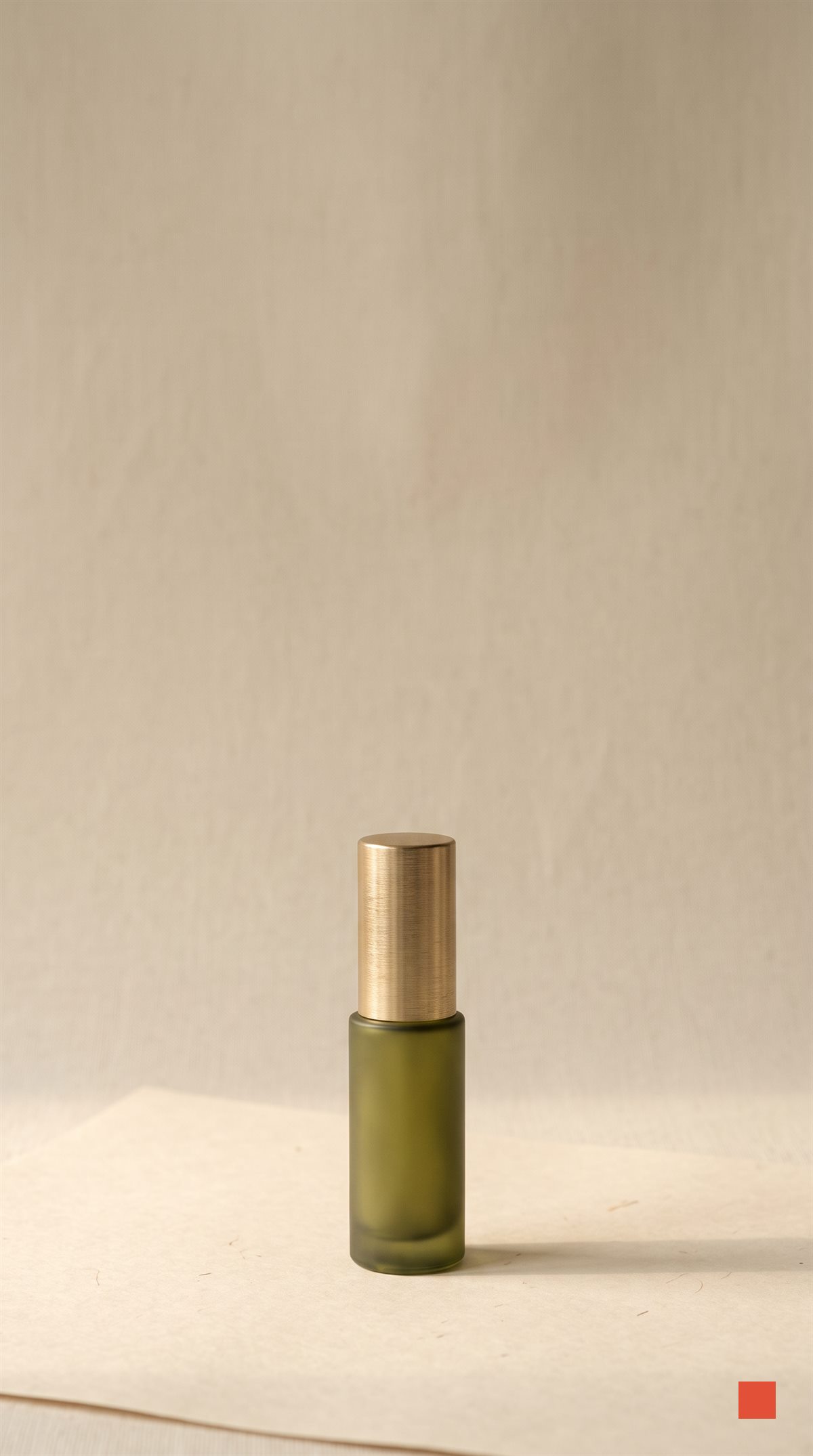 Olive serum tube with a brass cap on bone paper, generated in the app